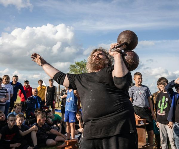 Man easily lifting a box, demonstrating functional strength in daily life.